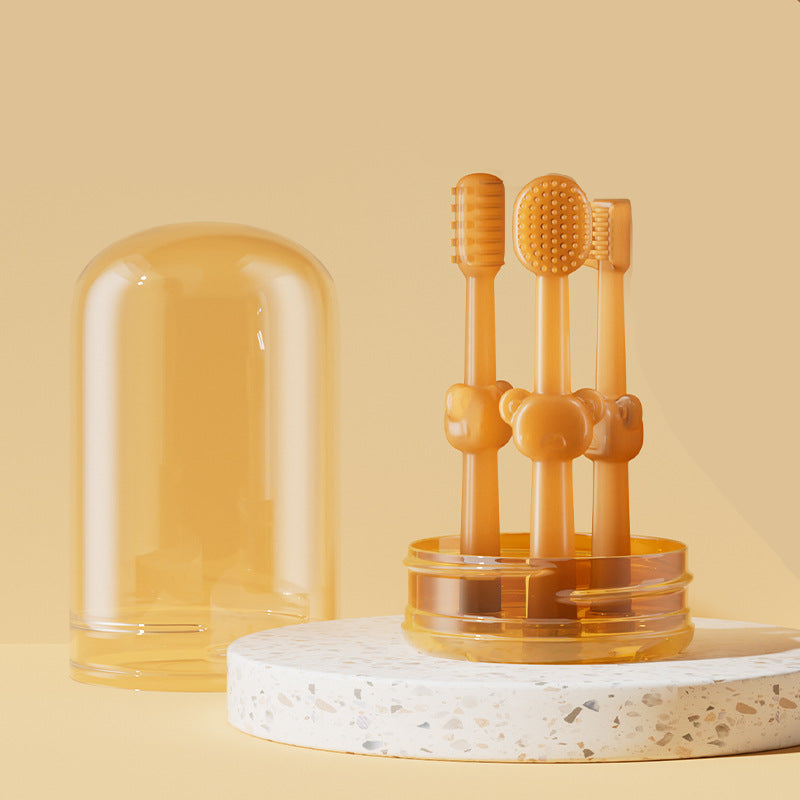 Set of three orange pet toothbrushes in a transparent stand on a beige background