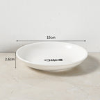 White ceramic bowl with measurements on a light surface